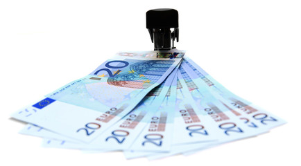 Stapler and money. On a white background.