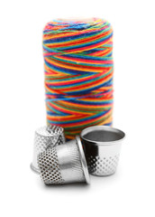 Threads and thimbles. On a white background.