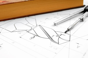 Compasses, the book and the drawing.
