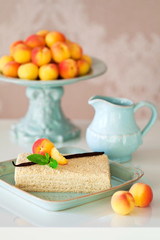 Cake with cream and fresh apricots, selective focus