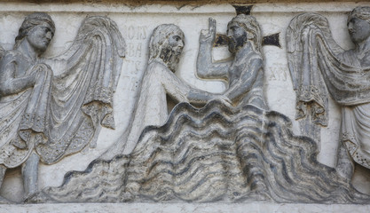 Fototapeta na wymiar Baptism of Jesus Christ relief at the baptistry, Parma, Italy