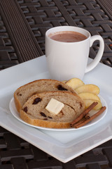 Platter with hot chocolate and whole wheat cinnamon raisin bread with apple slices