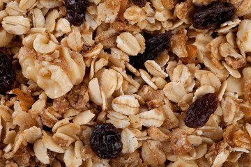Macro shot of homemade granola with oats, almonds, organic raisins, and walnuts