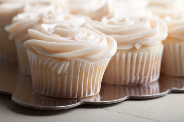 Gourmet strawberry filled cupcakes with white chocolate frosting - side view
