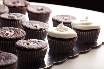 Chocolate gourmet cupcakes with buttercream frosting - side view