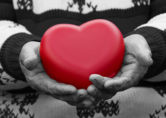 Hands senior, elderly woman holding red heart