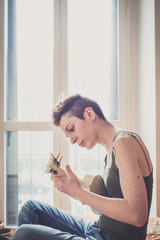 young lesbian stylish hair style woman playing guitar