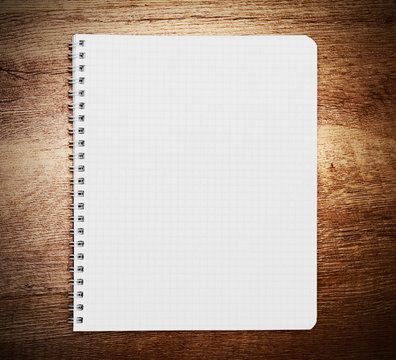 Notebook on wooden background.