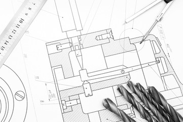 Compasses and drills on  drawing.