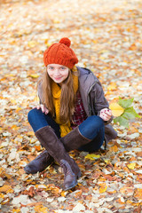 Girl relaxing in park on a fall day