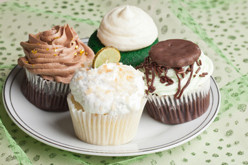 Coconut Key Lime Cupcake, Pot o' Gold chocolate caramel cupcake, Irish Mint cupcake, and Green Velvet cupcake for St. Patrick's Day