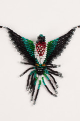 Fototapeta na wymiar Intricately beaded fashion jewelry of a majestic hummingbird necklace