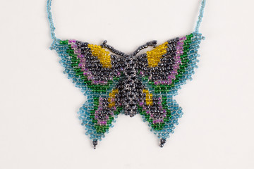 Intricately beaded fashion jewelry of a colorful butterfly