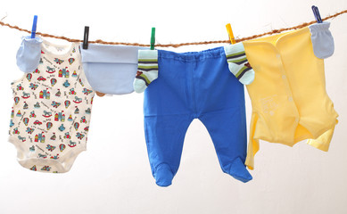 Baby clothes drying on rope. Kids underwear on white backgroud