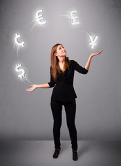 young lady standing and juggling with currency icons