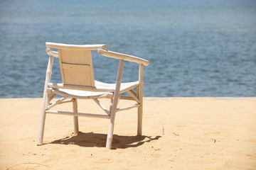White wood beach chair on nice sand beach