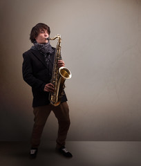 Young musician playing on saxophone