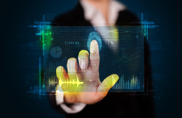 Young businesswoman pressing modern technology panel with finger