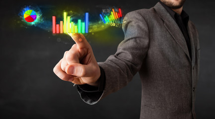 Handsome young business man touching colorful modern graph syste