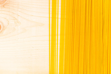 spaghetti on a wood background - top view