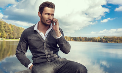 Handsome man talking on a smartphone