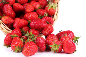Ripe sweet strawberries in wicker basket, isolated on white