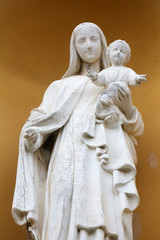Madona and Child, portal of the church, Porto Azzurro, Italy