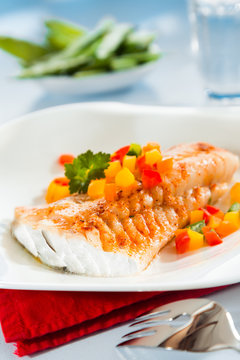 Grilled fish with colorful sweet peppers