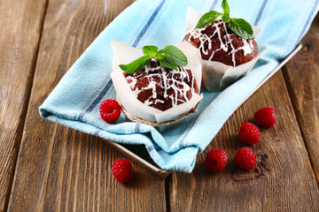Tasty cupcakes with raspberries on table close-up