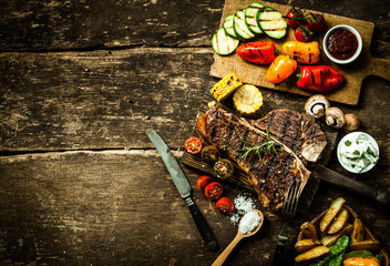 Colorful roast vegetables and grilled t-bone steak