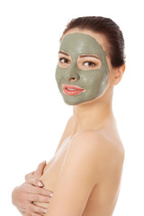 Beautiful woman with clay facial mask