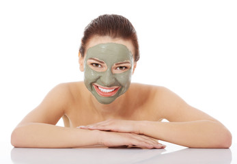 Beautiful woman with clay facial mask