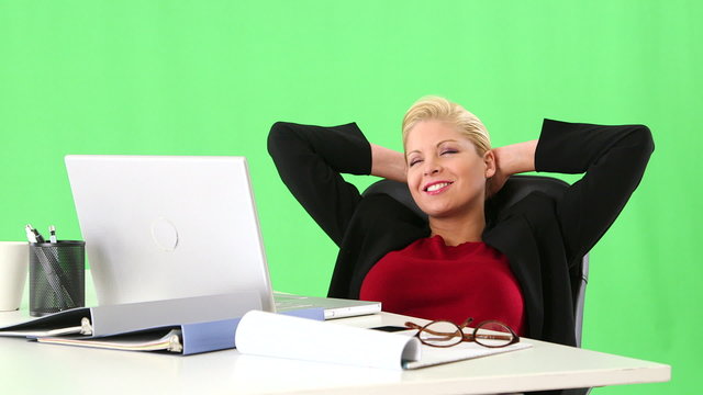 Positive businesswoman at desk with laptop showing excitement wh