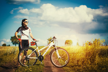 Fototapeta na wymiar Woman is riding bicycle outside