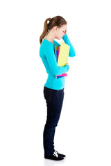 Fototapeta premium Young beautiful student woman with depression