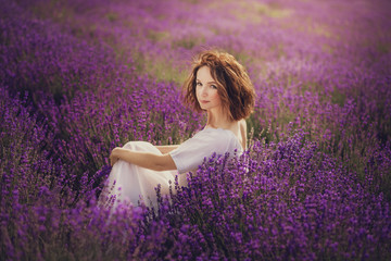 Smiling beautiful brunette in the lavender field
