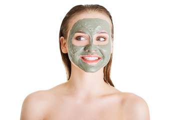 Beautiful woman with clay facial mask