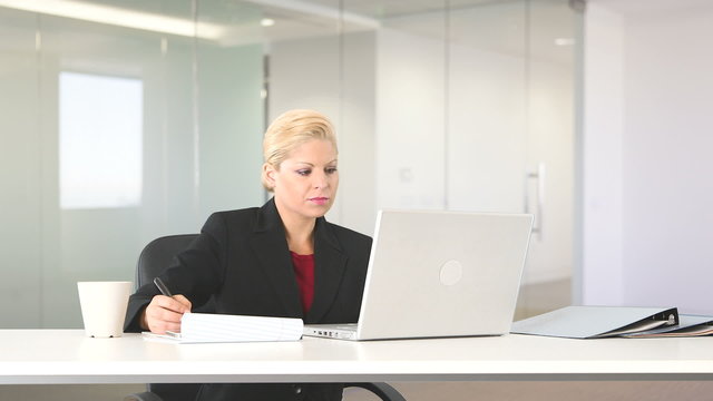 Executive businesswoman working with laptop at desk