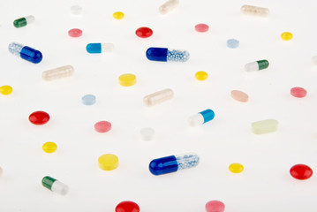 Color pills and capsules background isolated on white background