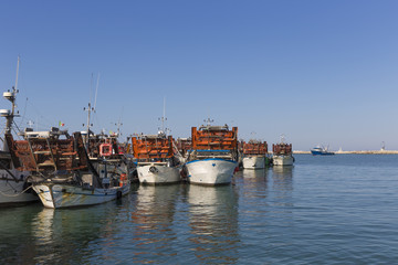 Fototapeta na wymiar fishing boats in harbor - machine to collect the clams