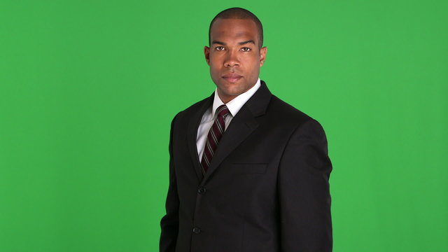 Portrait of executive standing and uncrossing arms