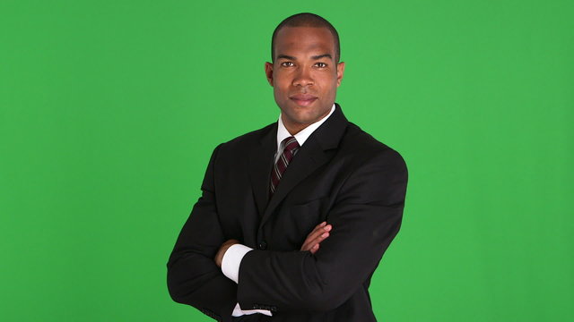 Portrait of executive standing and uncrossing arms