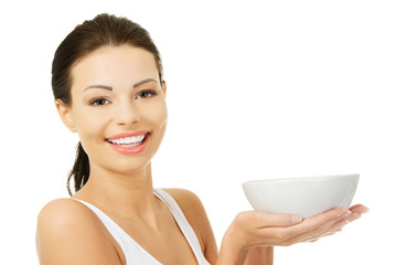 Beautiful young woman holding bowl