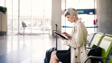 Businesswoman working with tablet at Charles de Gaulle airport,