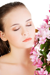 Fototapeta na wymiar Woman with healthy clean skin and pink flowers