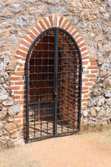 Wooden gate locked steel grate
