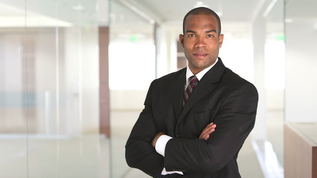 Portrait of executive standing and uncrossing arms