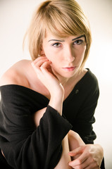 Fototapeta premium Woman in a loose, large black sweater close up