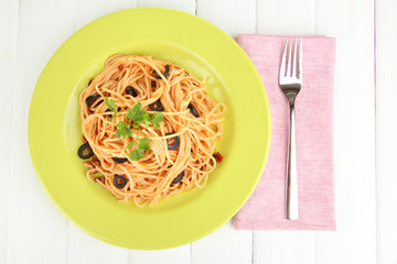 Italian spaghetti in plate on wooden table