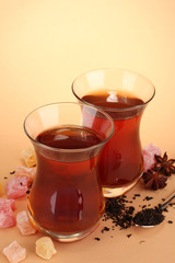 glasses of Turkish tea and rahat Delight, on beige background